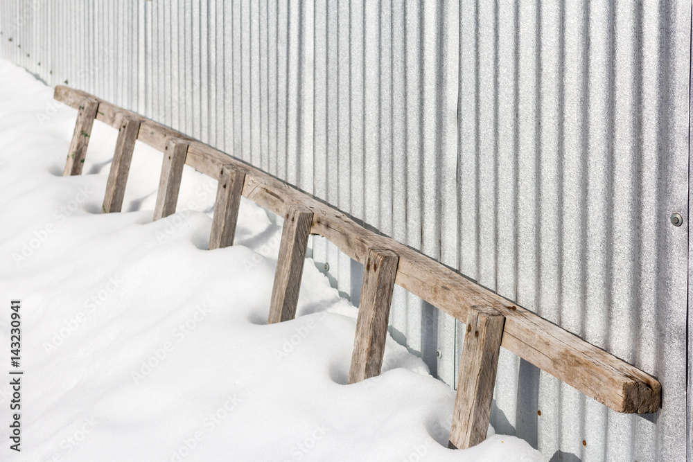 Rustic wooden ladder stuck in the snow. Stock Photo | Adobe Stock