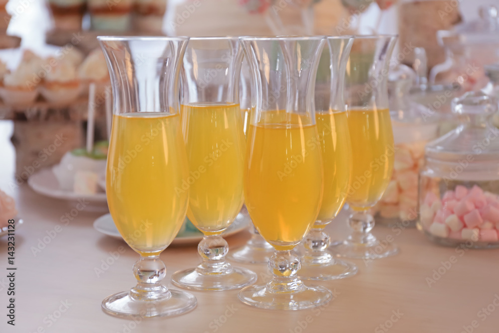 Glasses with juice on table prepared for party Glasses with juice on table prepared for party