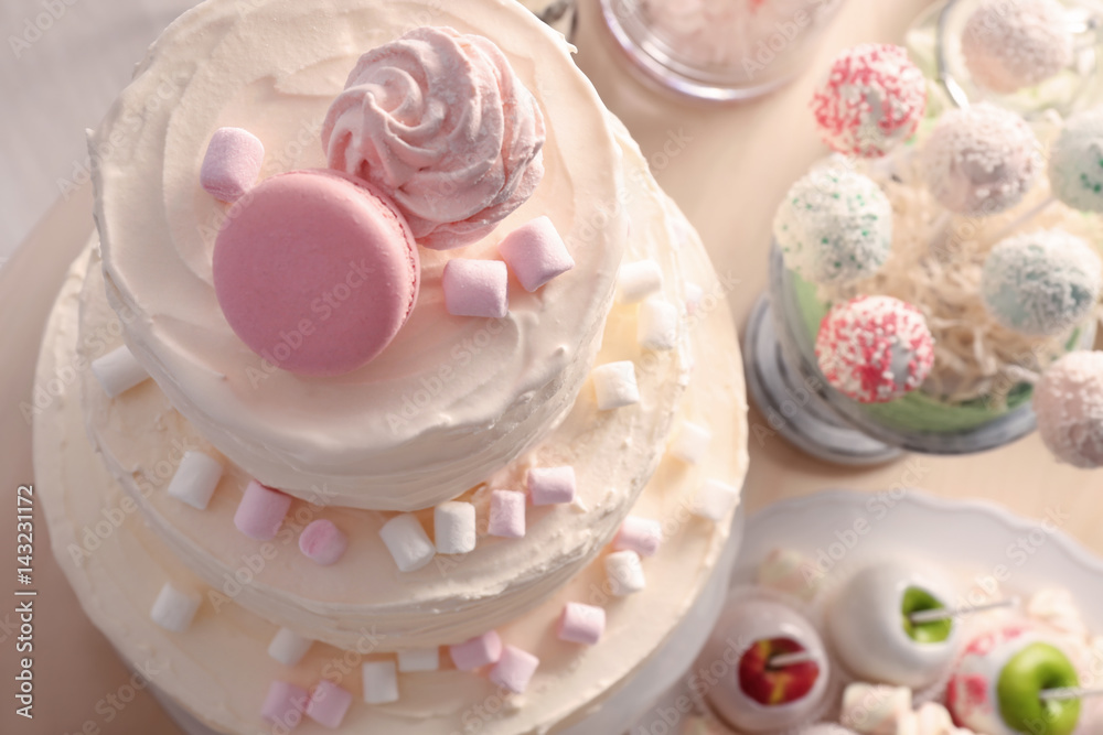 Tasty cake with sweets on table, closeup Tasty cake with sweets on table, closeup