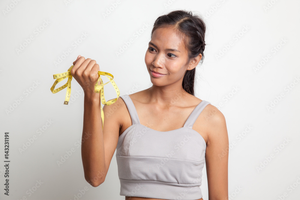 Young Asian woman with measuring tape. Young Asian woman with measuring tape.