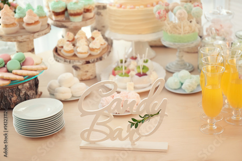 Wooden decor on table with sweets prepared for party