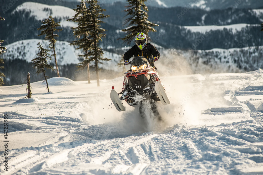 Rider on the snowmobile in the mountains. active drive Rider on the snowmobile in the mountains. active drive