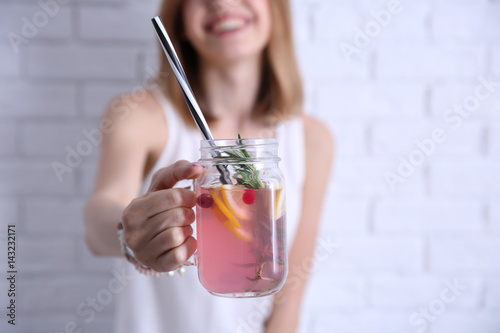 Young woman with lemonade n...