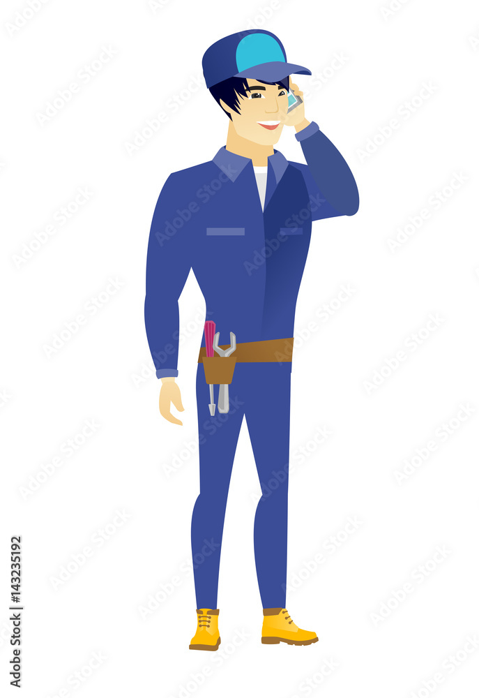 Mechanic talking on a mobile phone. Mechanic talking on a mobile phone.