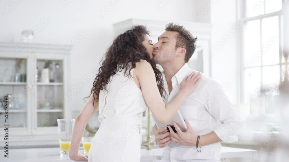 Happy romantic couple relaxing in apartment looking at computer tablet Happy romantic couple relaxing in apartment looking at computer tablet