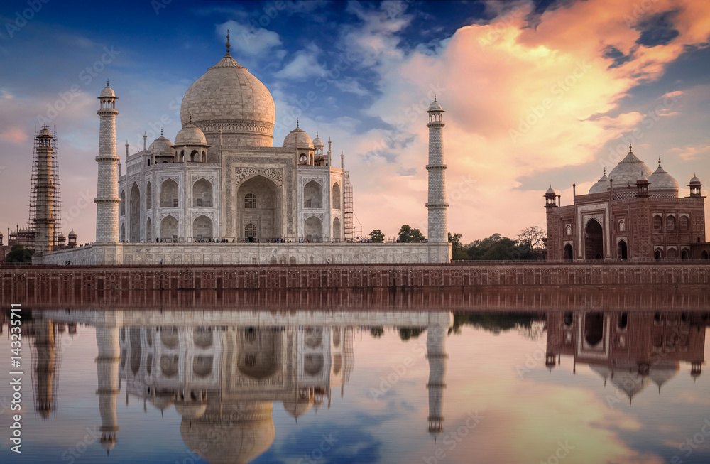 Taj Mahal with a scenic sunset view on the banks of river Yamuna. Taj Mahal is a white marble mausoleum designated as a UNESCO World heritage site at Agra, India.