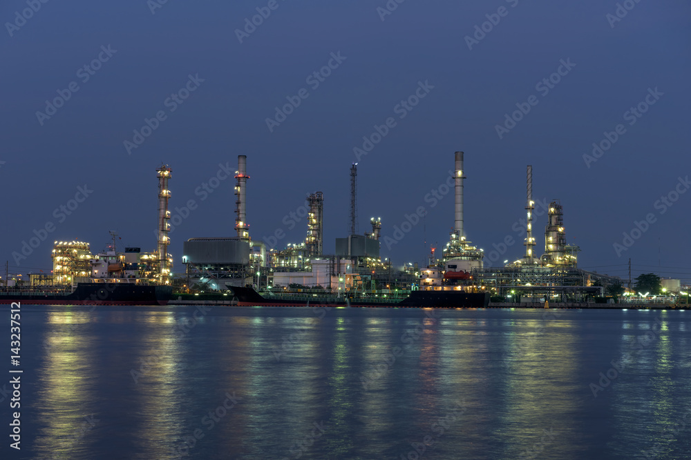 Refinery tower in petrochemical industrial plant with river
