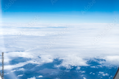 looking through airplane window to sea aerial view of cloud and sky