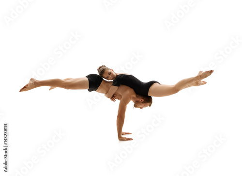 Young couple in sports clothes exercise in studio