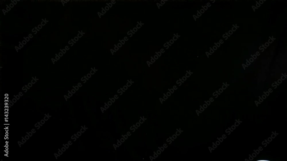 Football soccer goalkeeper jumping on black background