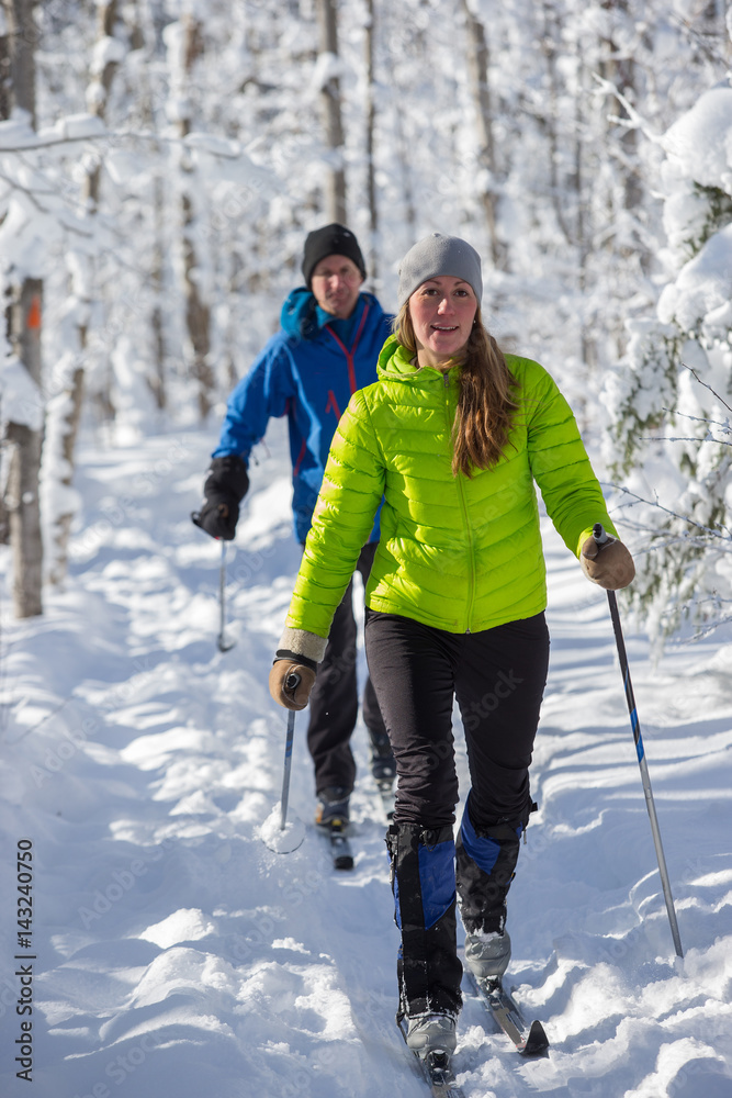 Couple cross country skiing in winter