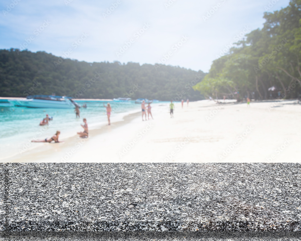 Obraz premium Marble Stone Table Top And Blur Background Of The Beach.
