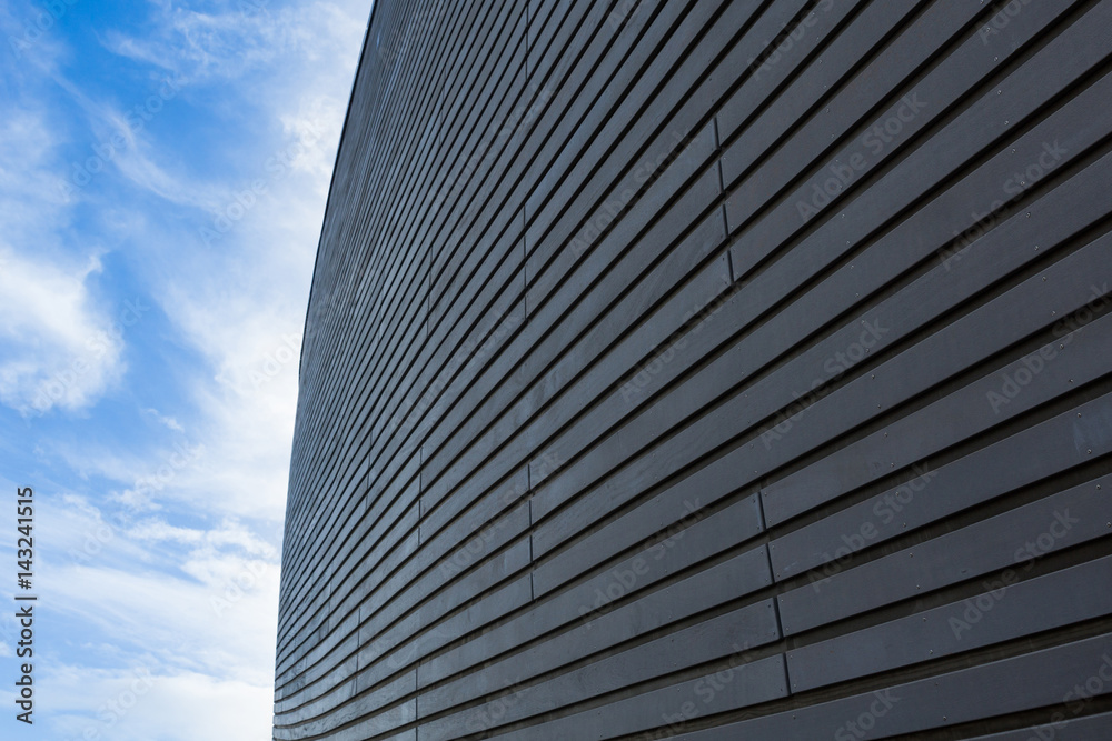 Dark wooden wall diminishing perspective into light cirrus clouded blue sky Dark wooden wall diminishing perspective into light cirrus clouded blue sky