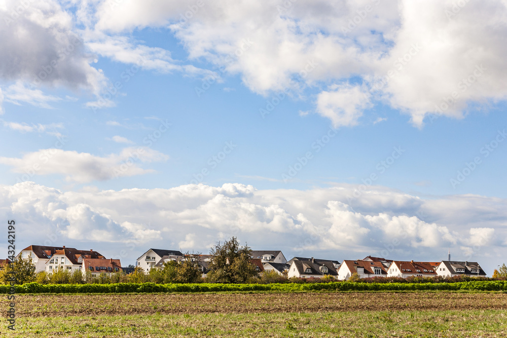 Obraz premium new housing area near the acre in beautiful landscape in middle of the farming area