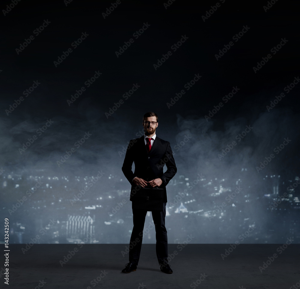 Businessman with briefcase standing over night city background. Job, business, career, concept. Businessman with briefcase standing over night city background. Job, business, career, concept.