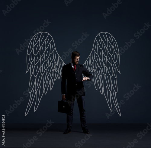 Business angel over dark background. Investment, business, sponsor concept. photo