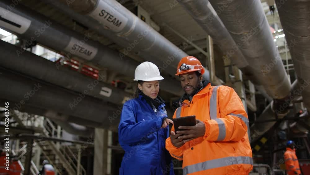 Portrait of engineer in power station looking at computer tablet. Portrait of engineer in power station looking at computer tablet.
