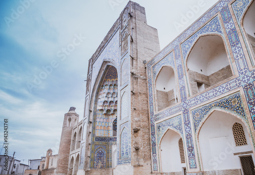 Front of Abdulaziz-Khan Madrasah. This Madrasah (1652) makes up an architectural ensemble with Ulugbek Madrasah but is more luxurious in its decor. It is the last large Madrasah in Bukhara, Uzbekistan photo