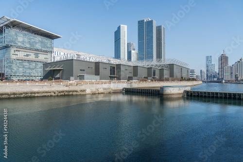 River And Modern Buildings Against Sky reflection of cityscape in river shot in Shanghai China.