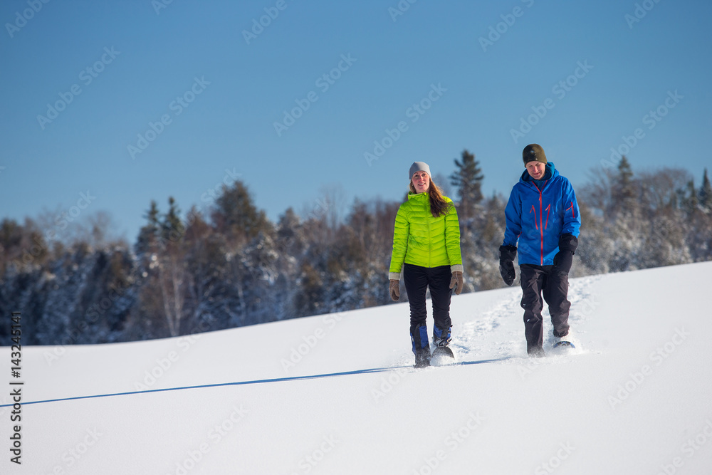 Couple Snowshoeing in fresh snow