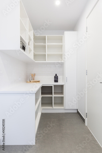 Large walk in butlers pantry storage area in a new home