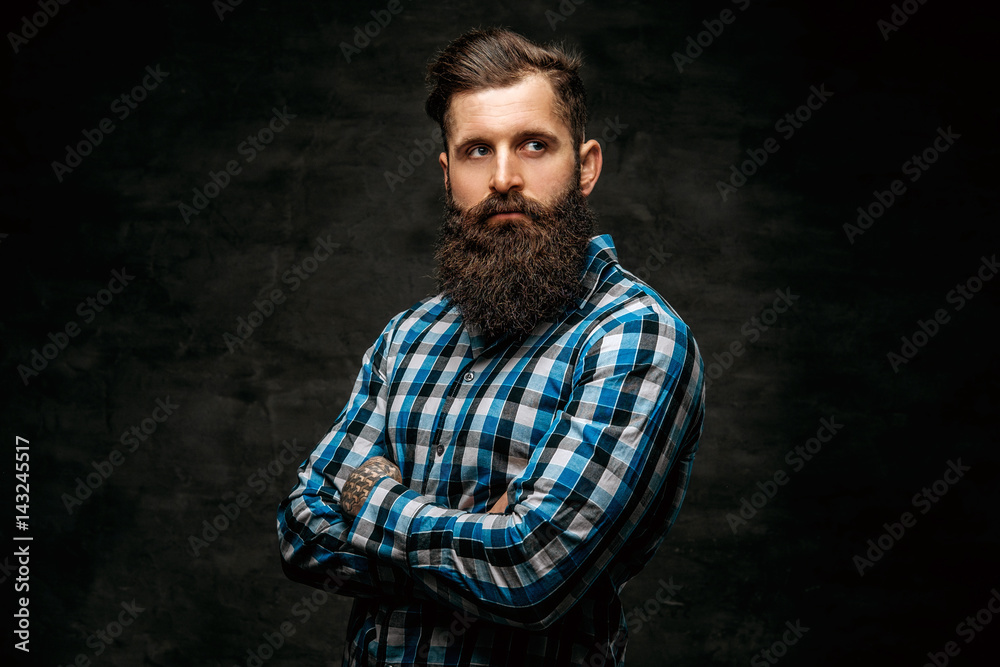 Bearded male with crossed arms, dressed in a blue fleece shirt. Bearded male with crossed arms, dressed in a blue fleece shirt.