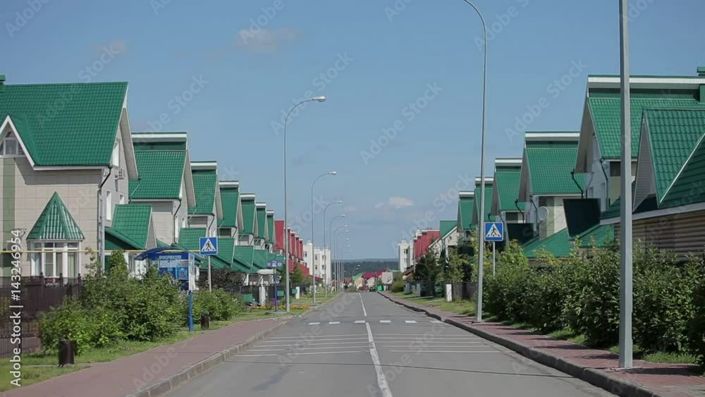 Nice and comfortable neighborhood. Some homes on empty street in the suburbs Nice and comfortable neighborhood. Some homes on empty street in the suburbs