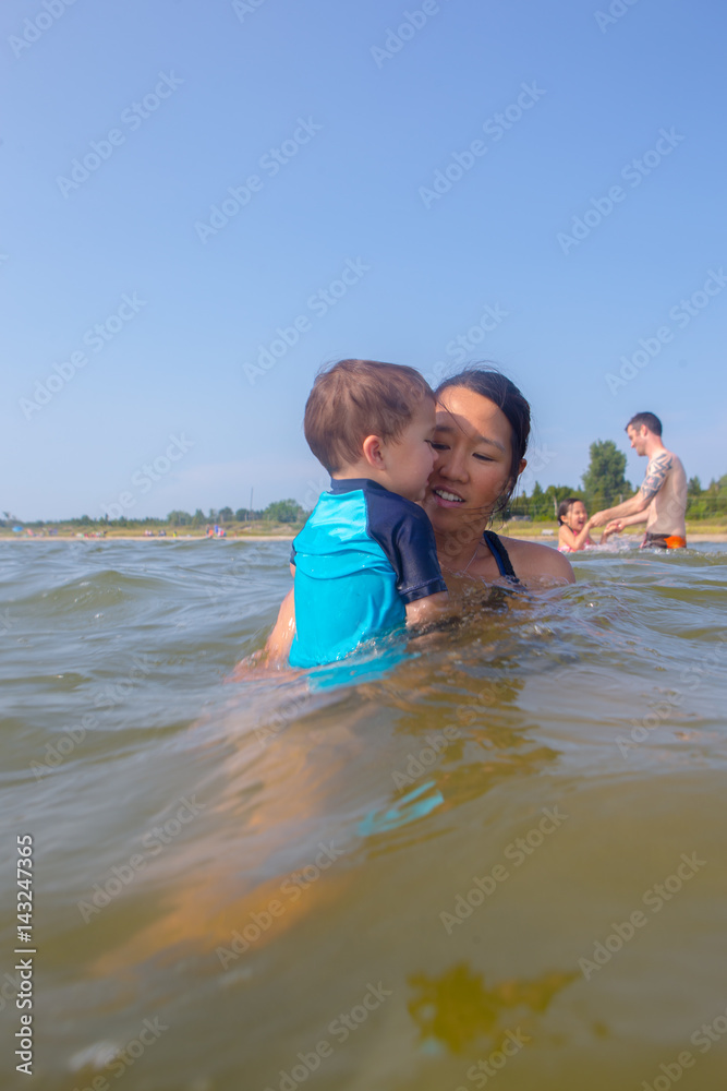 Mixed race family play at the beach