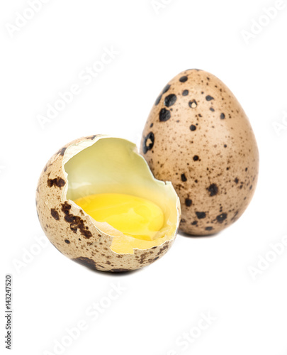 Raw broken quail egg on white background