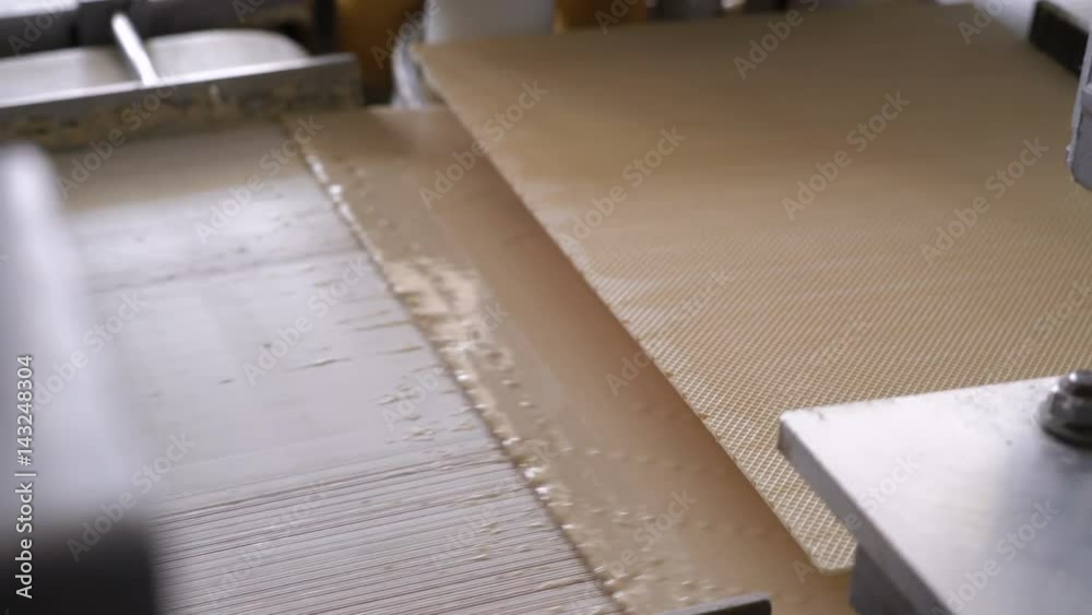 Production line for the production of wafers. Confectionery factory. Wafers with cream are fastened together. Close-up. Production line for the production of wafers. Confectionery factory. Wafers with cream are fastened together. Close-up.