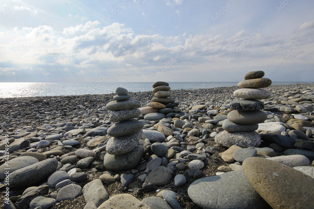 Pyramid of stones. The beach in Sochi in winter, next to the Olympic Avenue. Black Sea Pyramid of stones. The beach in Sochi in winter, next to the Olympic Avenue. Black Sea