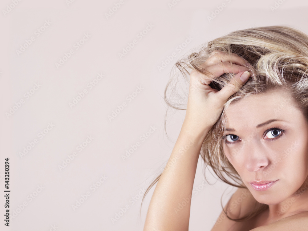 Portrait of sexy young woman with hand in hair