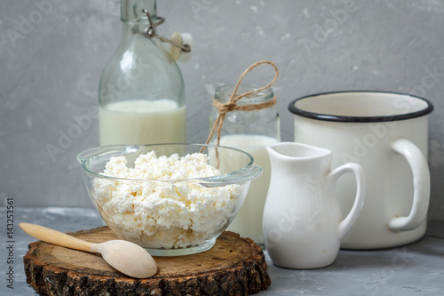 Various dairy products: Cottage cheese, bottle of milk on a dark background