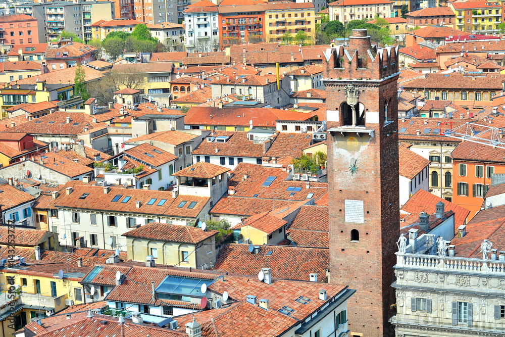 The great medieval tower with the oldest mechanical clock in Verona, Italy; panoramic photo.
