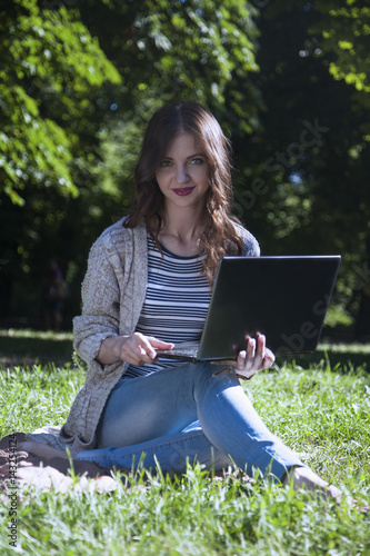 I love my work!!!I am a freelance!!! beautiful woman working with a laptop in a green park outdoors (time management, success, freedom)