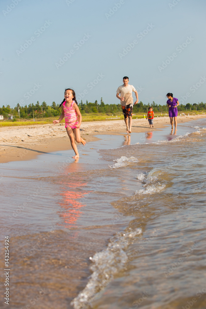 Obraz premium Mixed Race family at the beach