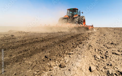 Tractor preparing land