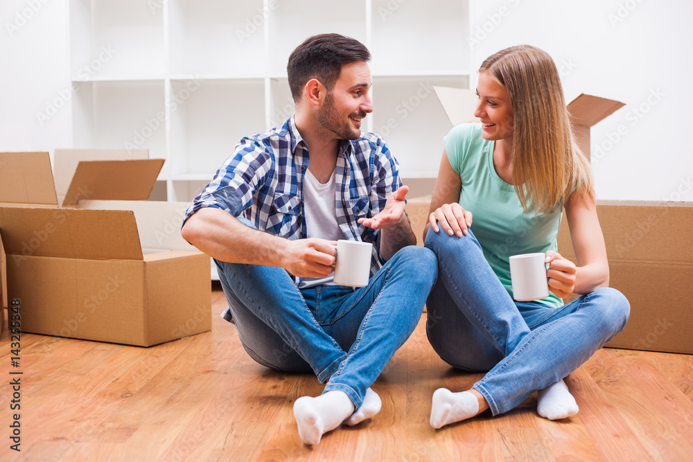 Young couple is moving in their new home. It's time for unpacking. Young couple is moving in their new home. It's time for unpacking.