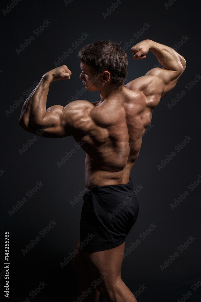 Handsome power bodybuilder showing his back Handsome power bodybuilder showing his back