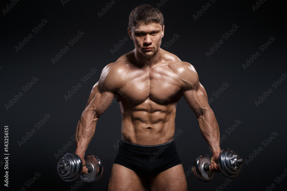 Strong and power bodybuilder doing exercises with dumbbell Strong and power bodybuilder doing exercises with dumbbell