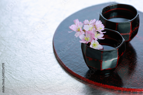 Japanese traditional sake cups with sakura flowers.