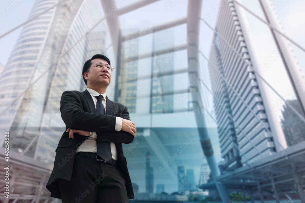 Confident Asian Businessman standing and looking at city for vision concept Confident Asian Businessman standing and looking at city for vision concept
