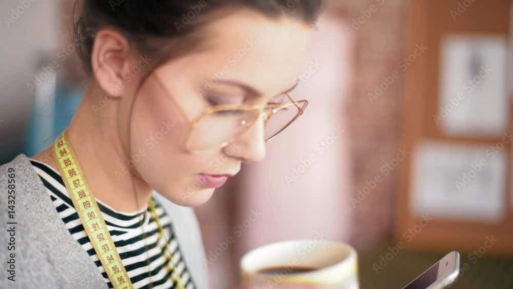 Professional dressmaker taking coffee break Professional dressmaker taking coffee break
