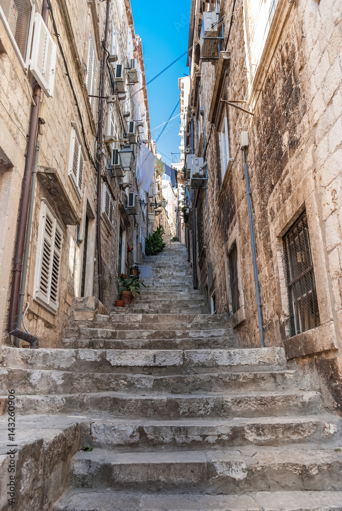 Narrow stone steps going up from the old town in Dubrovnik to streets and alleys above.