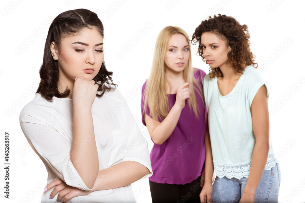 Two women gossiping about young woman on the front Two women gossiping about young woman on the front