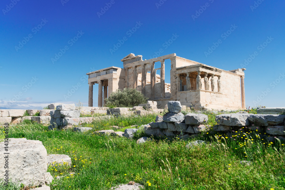 Erechtheion temple with green grass in Acropolis of Athens, Greece