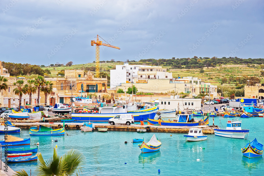 Luzzu colored boats at Marsaxlokk Harbor in Malta
