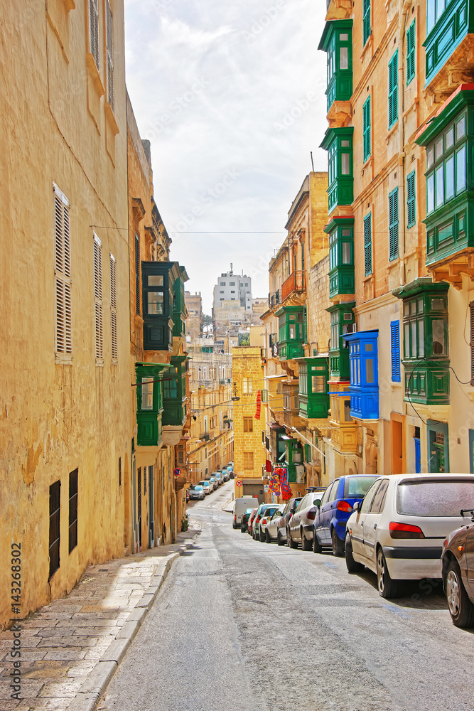 Old street with traditional houses at city center of Valletta