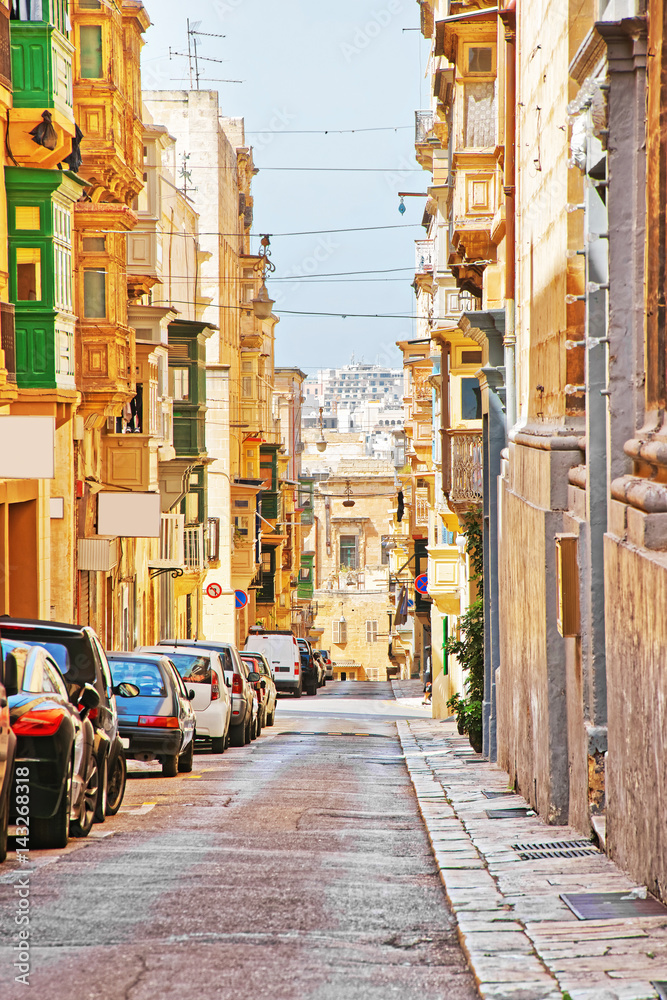 Old street with traditional houses in city center Valletta
