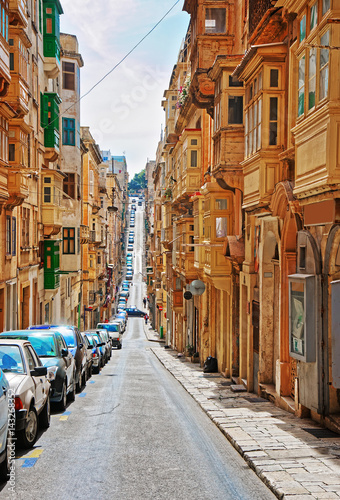 Old street with traditional houses in city center of Valletta